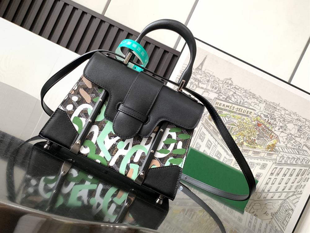 The front of the limited edition Sagon mini bag for 2023 is adorned with a letter camouflage pattern reinterpreting the classic Yshaped pattern of t