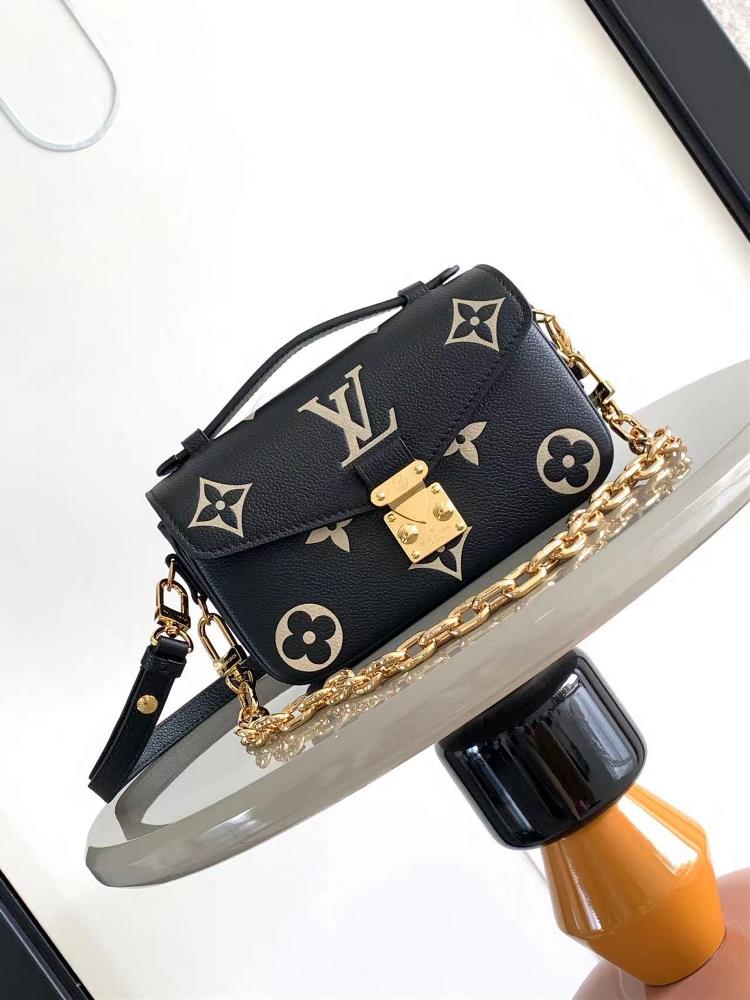 The M46595 black silk screen printed Pochette Mtis East West handbag is made of Monogram Imprente embossed leather showcasing the fusion of brand sty