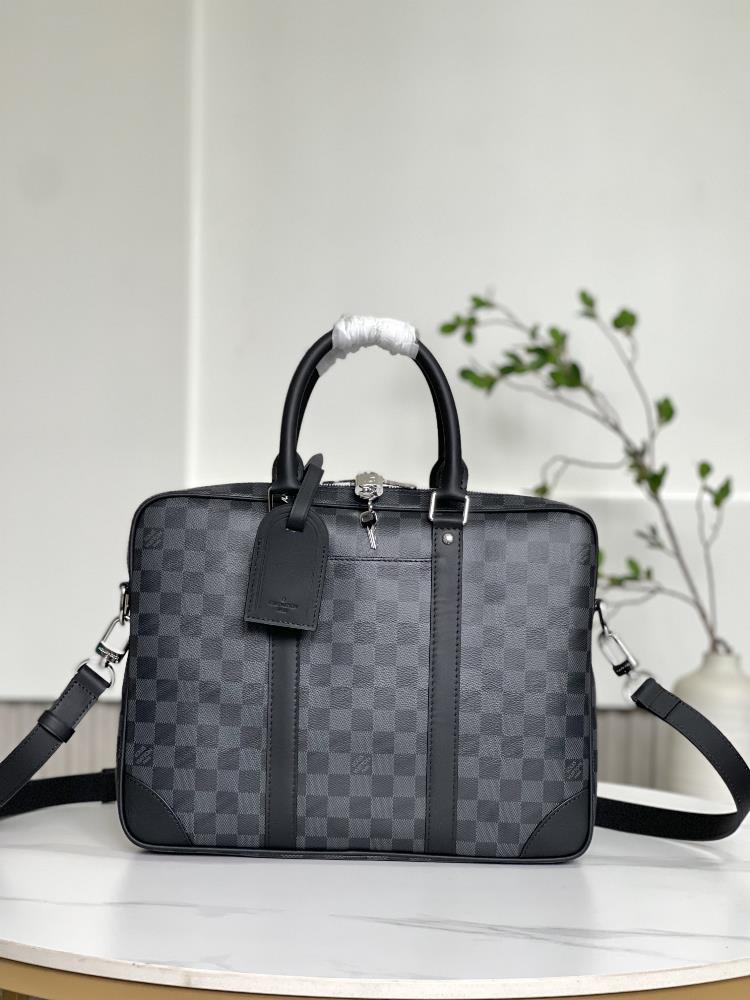 N40445   This Voyage small briefcase is made of Damier Graphite coated canvas paired with leather side straps reinforced corners top handle and a