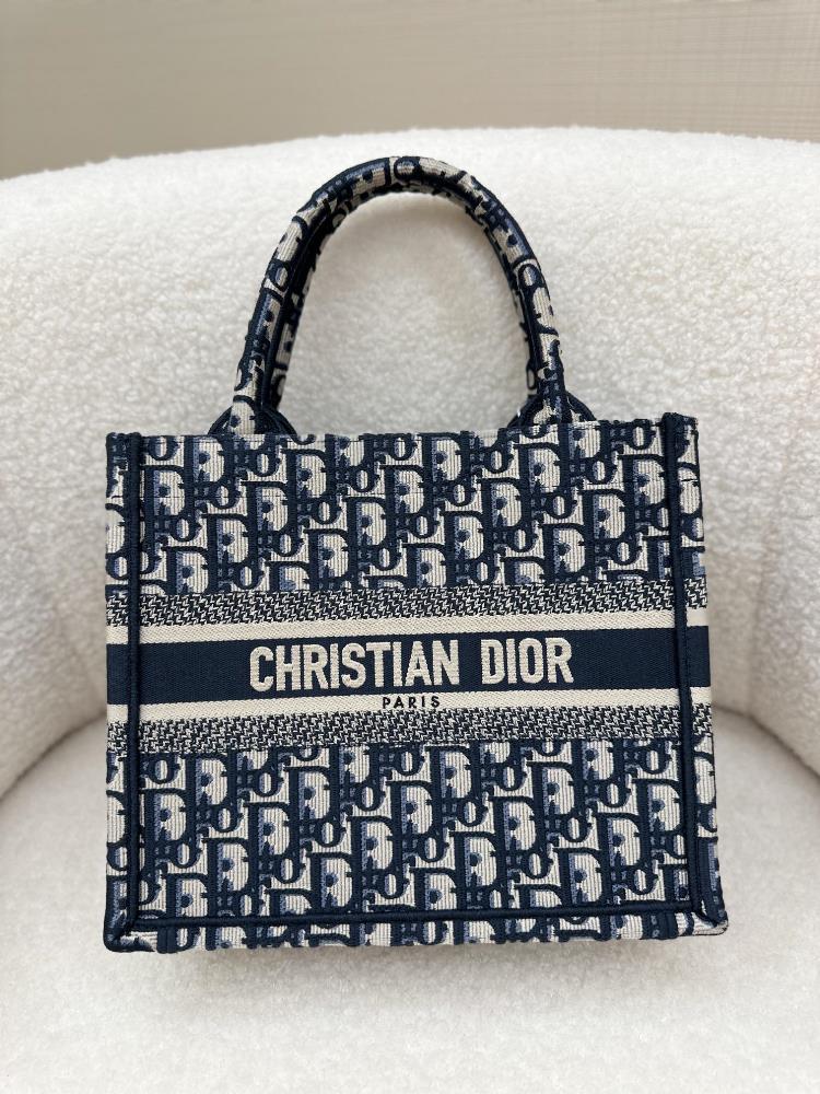 This Book Tote handbag was designed by Maria Grazia Chiuri creative director of Dior womens clothing and is a flagship product that embodies Diors