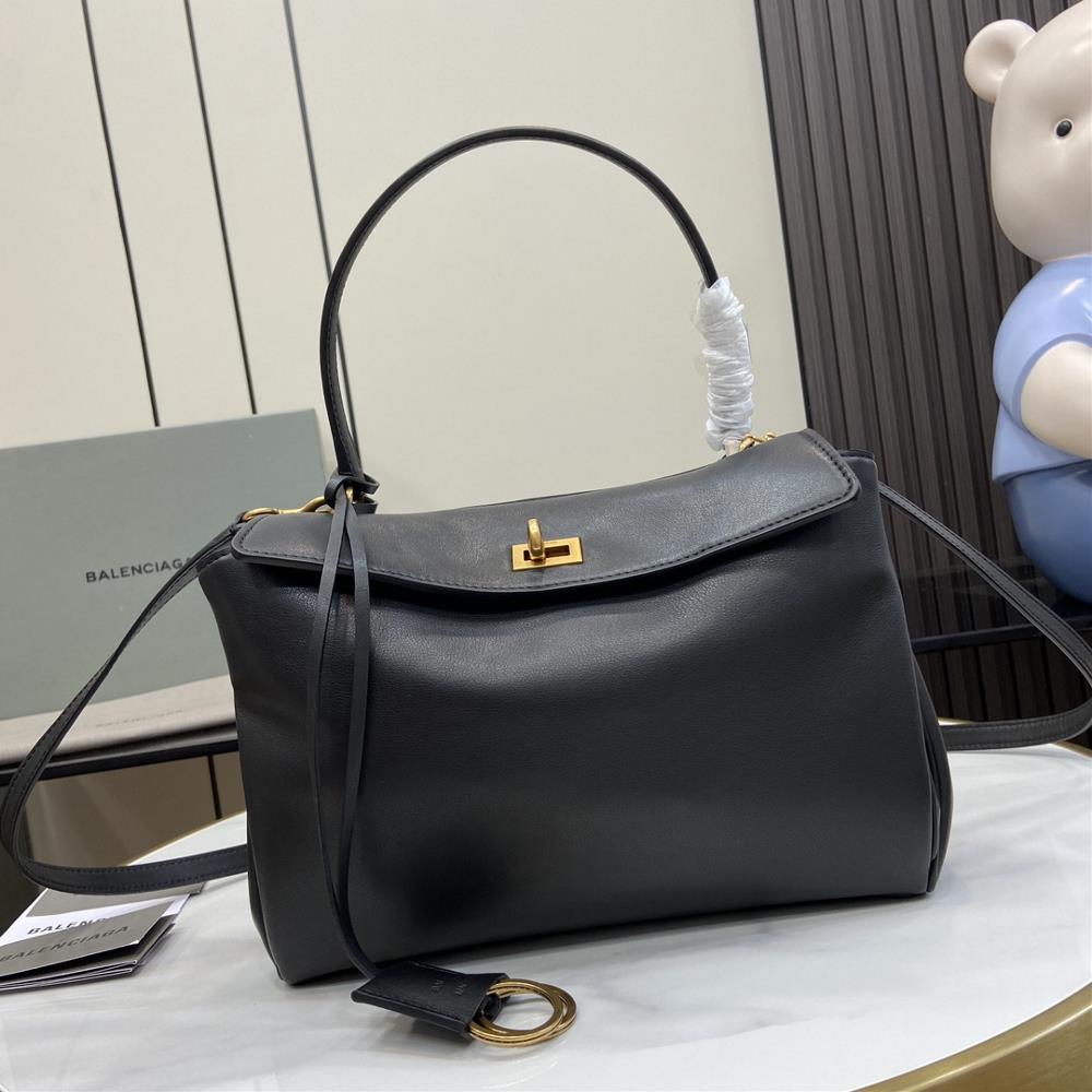 Balenciaga has shipped the goodsThe Rodeo black handbag with old gold metal accessories is inspired by a lot of dystopian coolness and vintage eff
