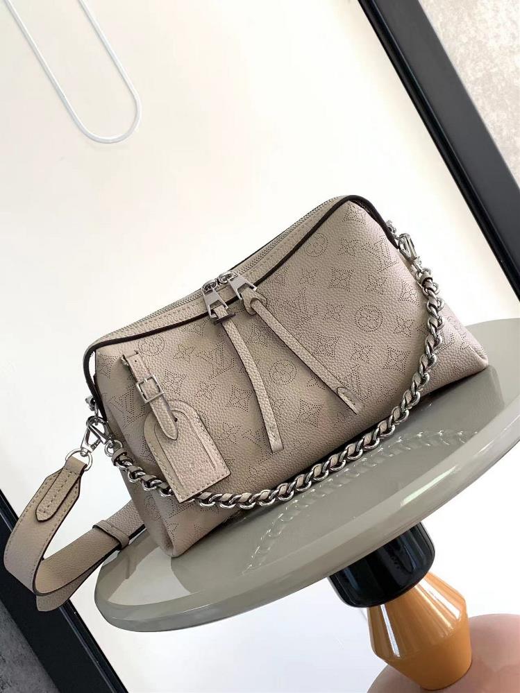 M24255 M24114This Mahina Hand It All small handbag is made of delicate perforated cowhide leather and features an elegant draped texture to accentuate