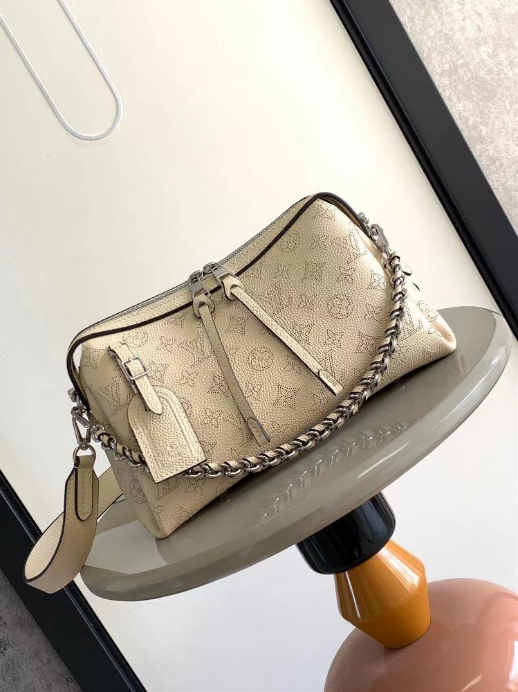 M24255 M24114This Mahina Hand It All small handbag is made of delicate perforated cowhide leather and features an elegant draped texture to accentuate