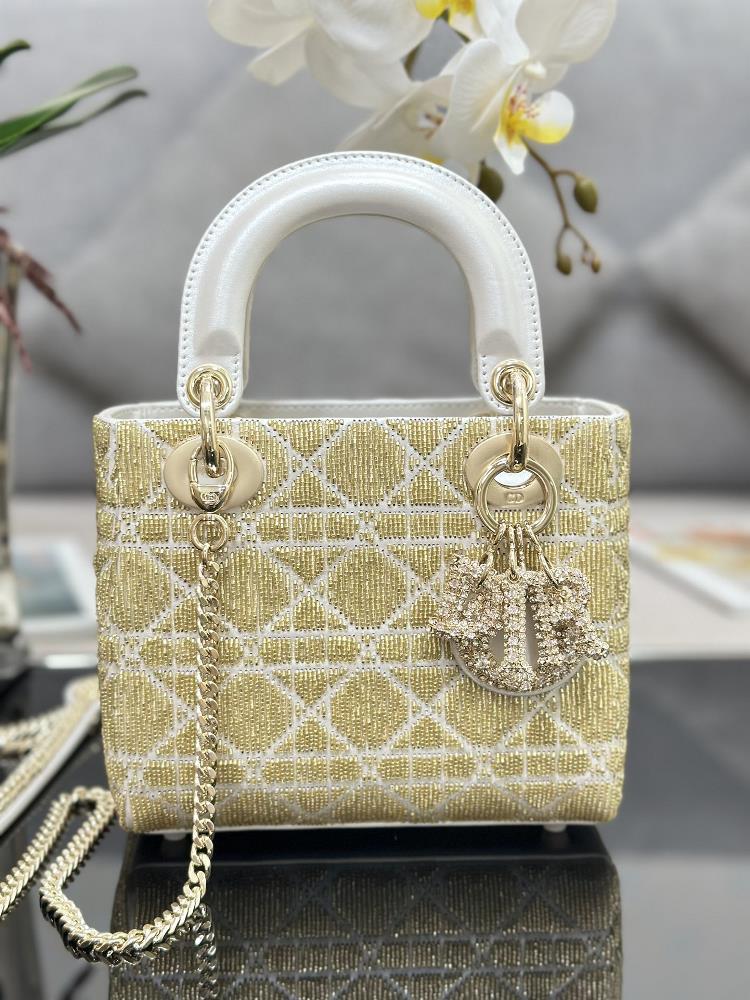 Lady Diors three panel embroidered limited edition pearl tube in gold with lamb tendon lining limited edition crystal pendant and handbag reflect