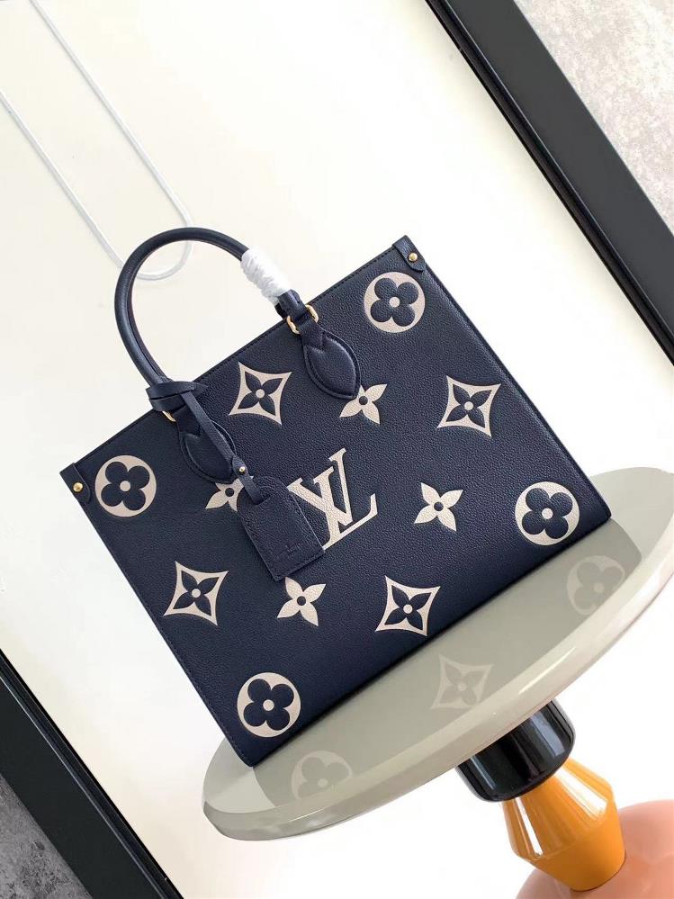 M45495 M45595 dark blueThis OnTheGo medium tote bag features a Monogram pattern first printed and then pressed onto soft grain leather Its ample inte