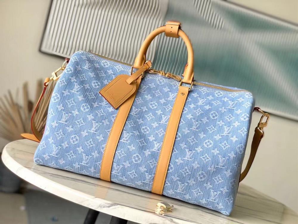 Top of the line original M25334 KEEPALL BANDOULI This travel bag features a Monogram Denim material that echoes the summer overture The cotton fabric