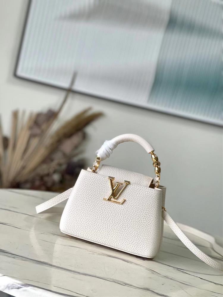 The M23944 white mini Capuchines mini handbag features exquisite Monogram flowers on the handle presenting a threedimensional appearance of the LV l