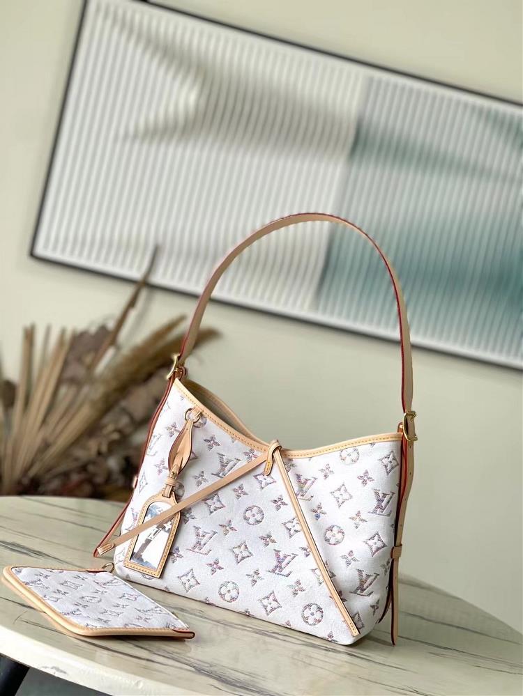 The M24707 CarryAll small handbag is from the Nautical collection featuring Monogram jacquard fabric with cowhide leather trim Colorful yarns weave