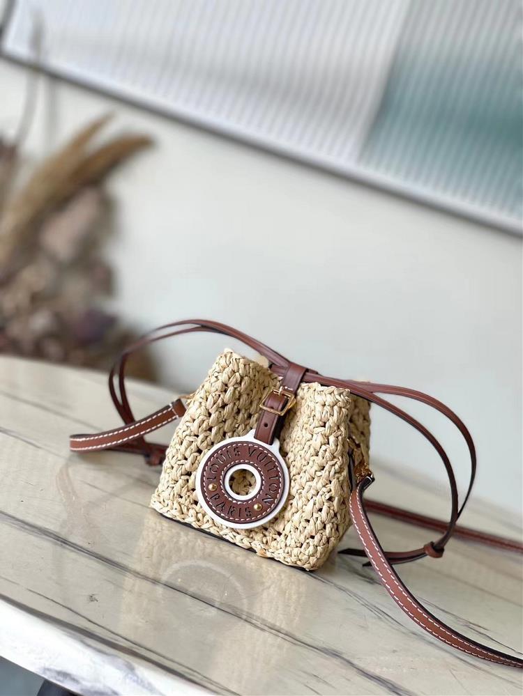 The top of the line original M83521 this NoePulse handbag features crocheted Lafite grass with leather trim and a drawstring design inspired by the