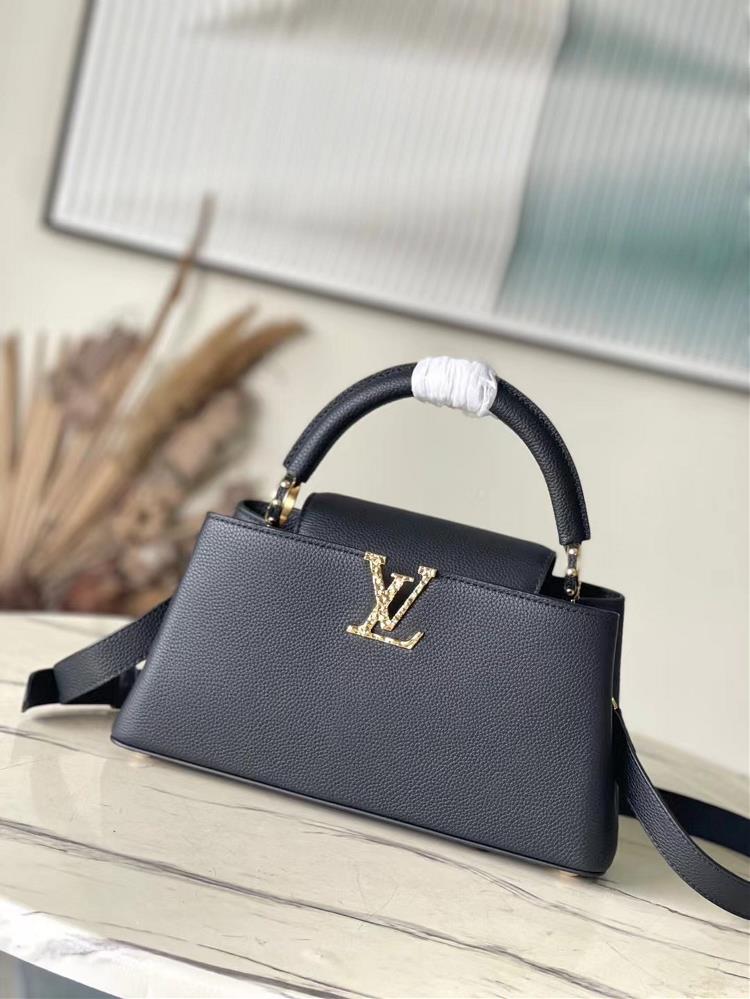 M24664 Black MediumThis Capucines East West medium handbag is from the LVCrush collection featuring a grain cowhide leather body illuminated by the L