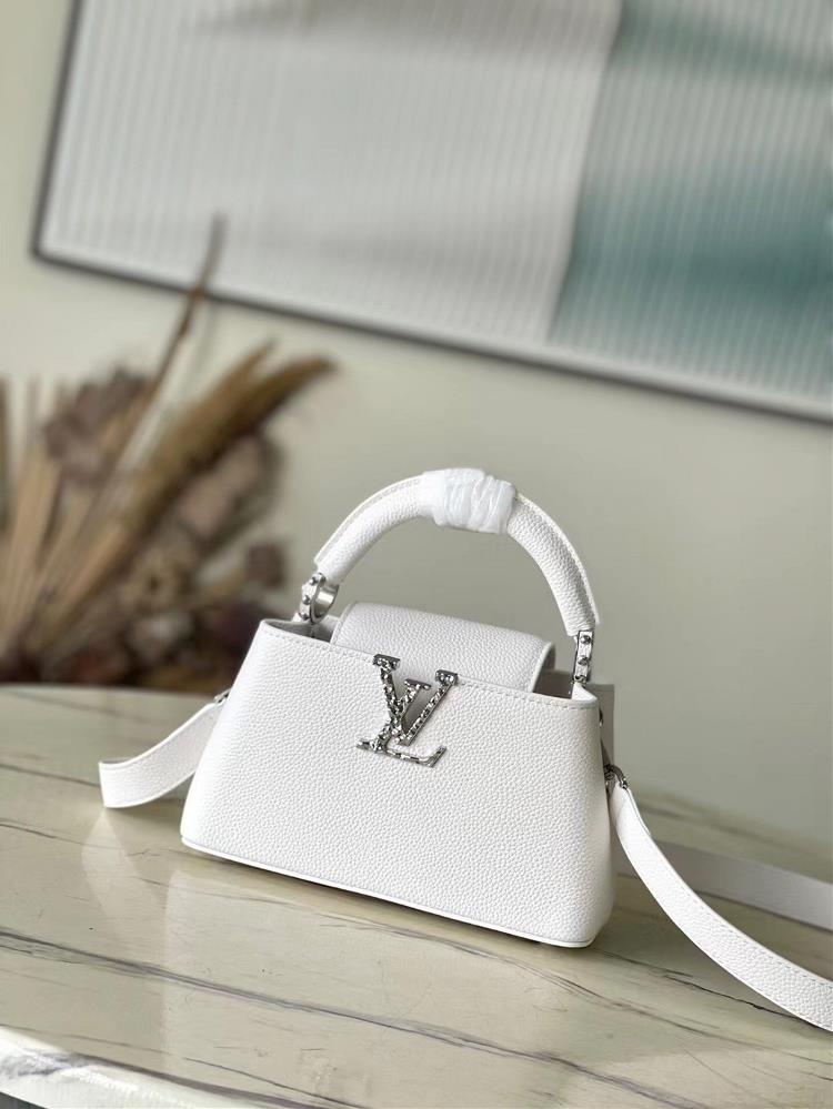 M24671 white miniThis Capucines EastWest mini handbag is made of grain leather embellished with LV letters featuring an elegant design that includes