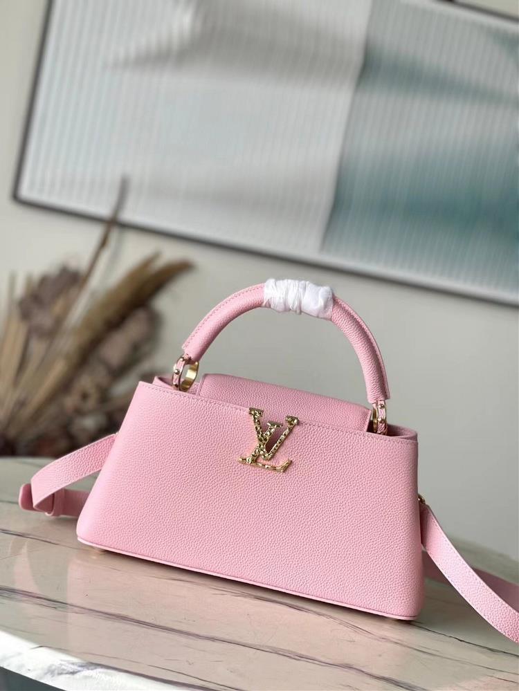 M24666 Pink MediumThis Capucines East West medium handbag is from the LVCrush collection featuring a grain cowhide leather body illuminated by the LV