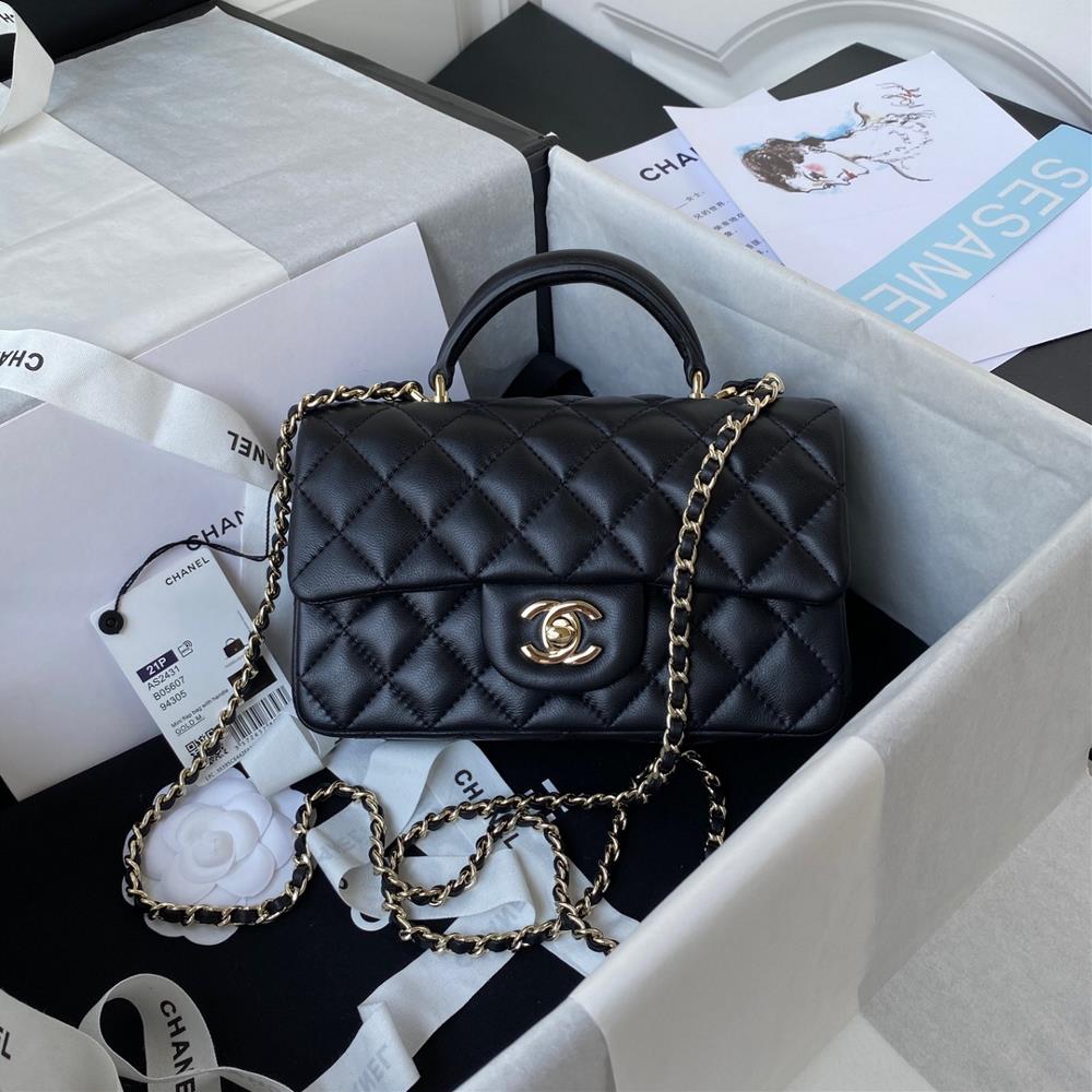 The latest Mini CF handle handbag AS2431 from Chanel 21K in light gold features a classic diamond grille cover adorned with a delicate classic chain a