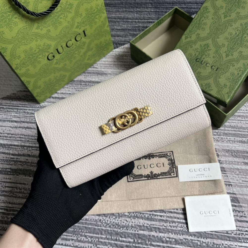 This long wallet comes with a complete set of packaging and is made of refined white leather The front bow is crafted with python skin rolled edges