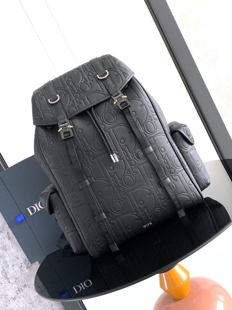 This Dior Hit The Road flip backpack blends modern style with Diors haute couture spirit The Dior Gravity printed effect leather uses embossing tech