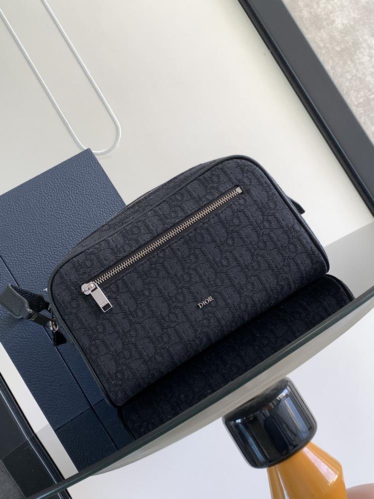 This toiletry bag combines practical functions with a minimalist design Crafted with black Oblique printed fabric adorned with grain leather trim in