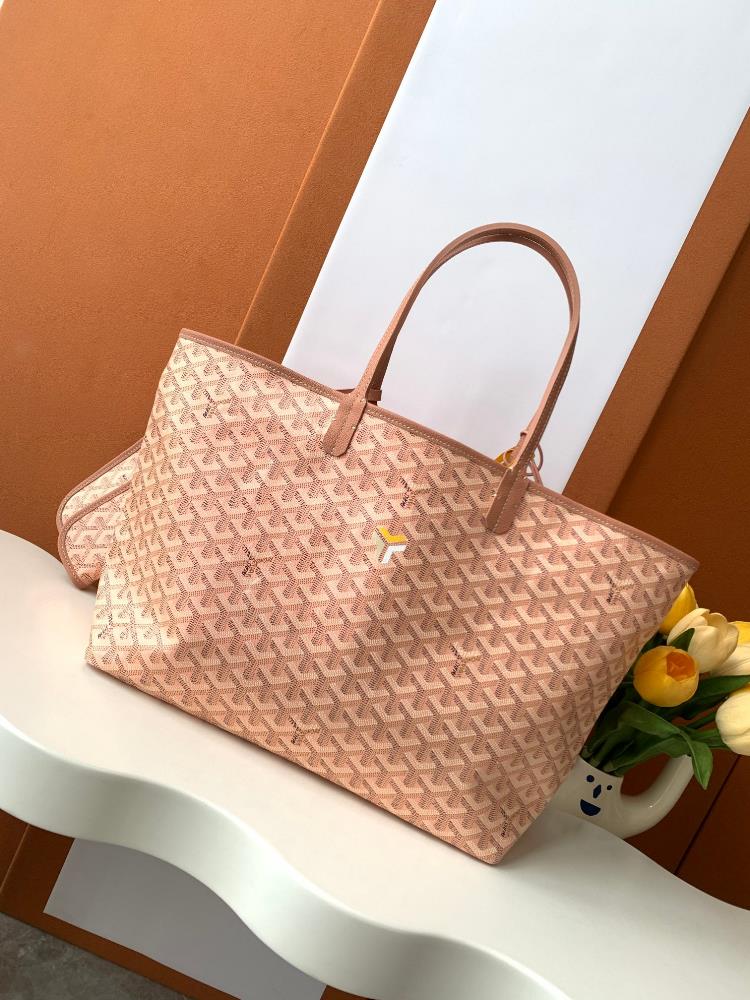 As a limited edition for 2024 the handbag features a unique pearl colored GOYARDINE canvas with a rainbow like shimmering effect This exclusive limi