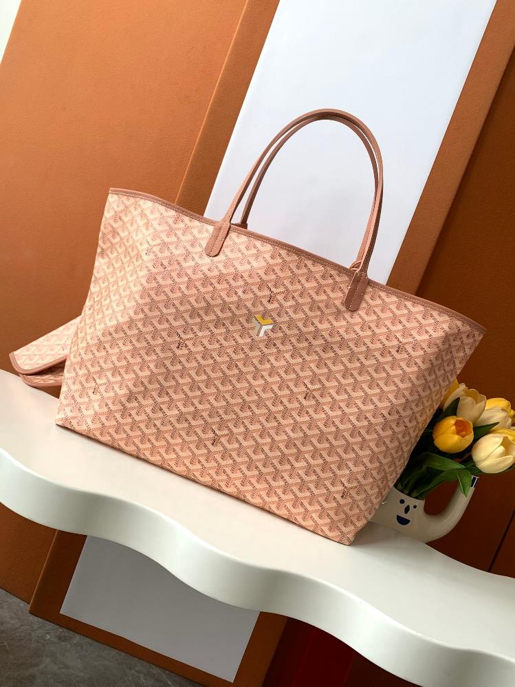 As a limited edition for 2024 the handbag features a unique pearl colored GOYARDINE canvas with a rainbow like shimmering effect This exclusive limi