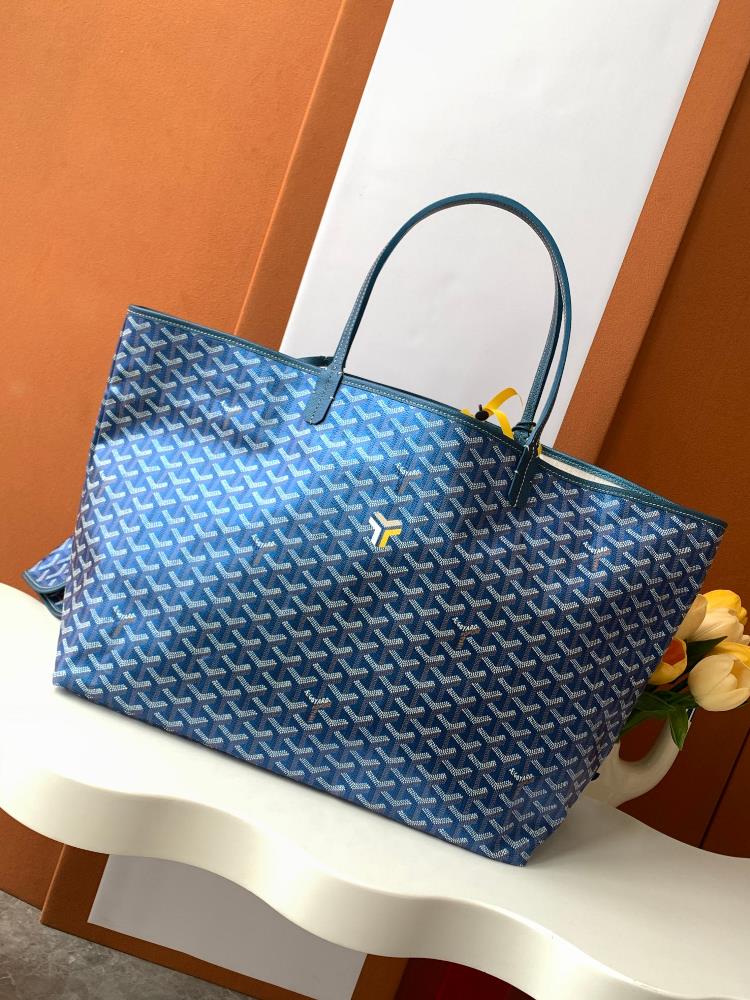 As a limited edition for 2024 the handbag features a unique pearl colored GOYARDINE canvas with a rainbow like shimmering effect This exclusive limi