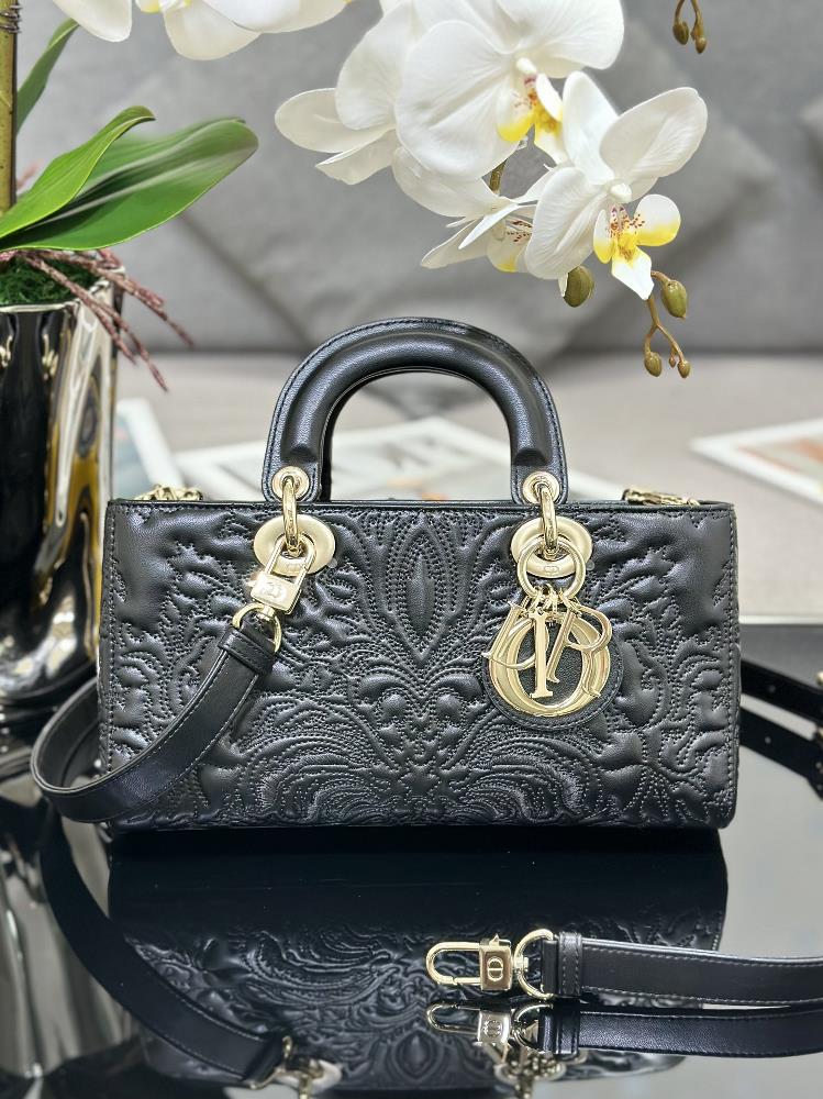 The Lady DJoy horizontal relief is black with prominent stitching details created by rattan pattern stitching adorned with hand embroidered Ornament