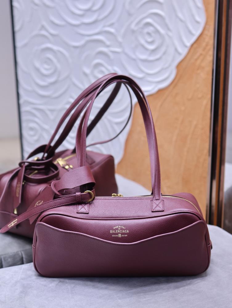 Parisian Maison CARRIE Small Bowling Bag in Jujube RedBalenciaga deconstructs traditional frameworks with avantgarde aesthetics constantly breaking