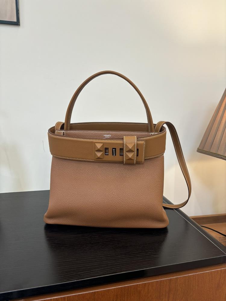 The new Medor bag is sewn with 27cm semi handmade wax thread and features a leather material inspired by a bell pull It is also decorated with pyrami