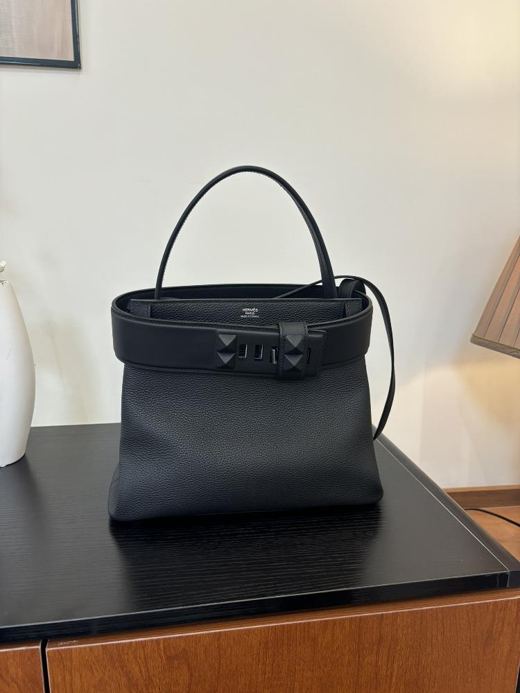 The new Medor bag is sewn with 27cm semi handmade wax thread and features a leather material inspired by a bell pull It is also decorated with pyrami