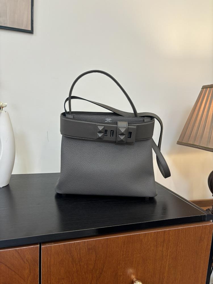 The new Medor bag is sewn with 27cm semi handmade wax thread and features a leather material inspired by a bell pull It is also decorated with pyrami