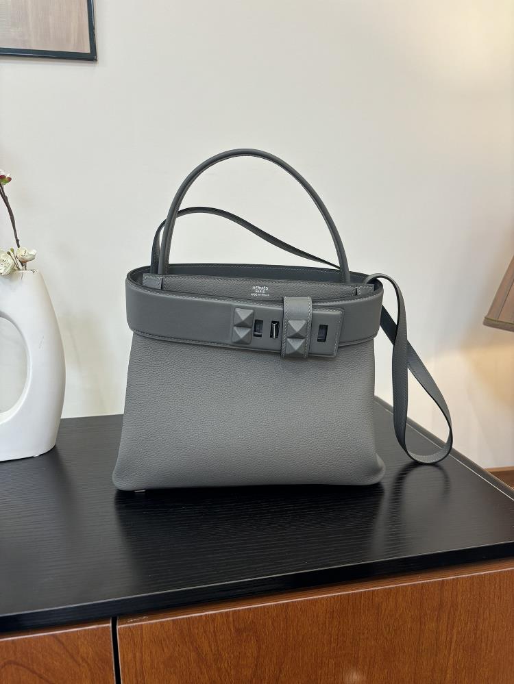 The new Medor bag is sewn with 27cm semi handmade wax thread and features a leather material inspired by a bell pull It is also decorated with pyrami